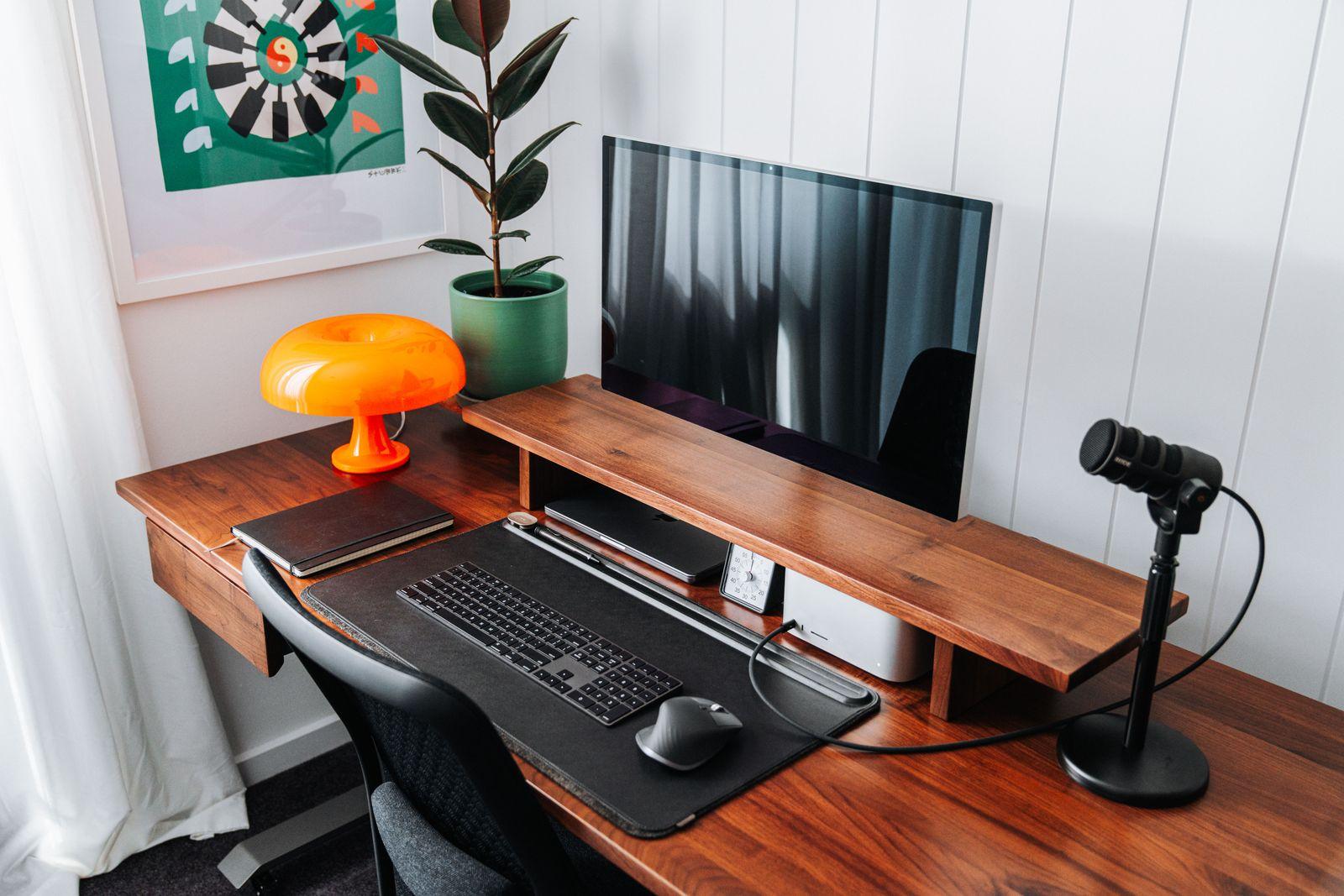a computer desk with a mouse and keyboard on it