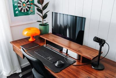 a computer desk with a mouse and keyboard on it