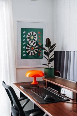 a desk with a laptop and a monitor on it