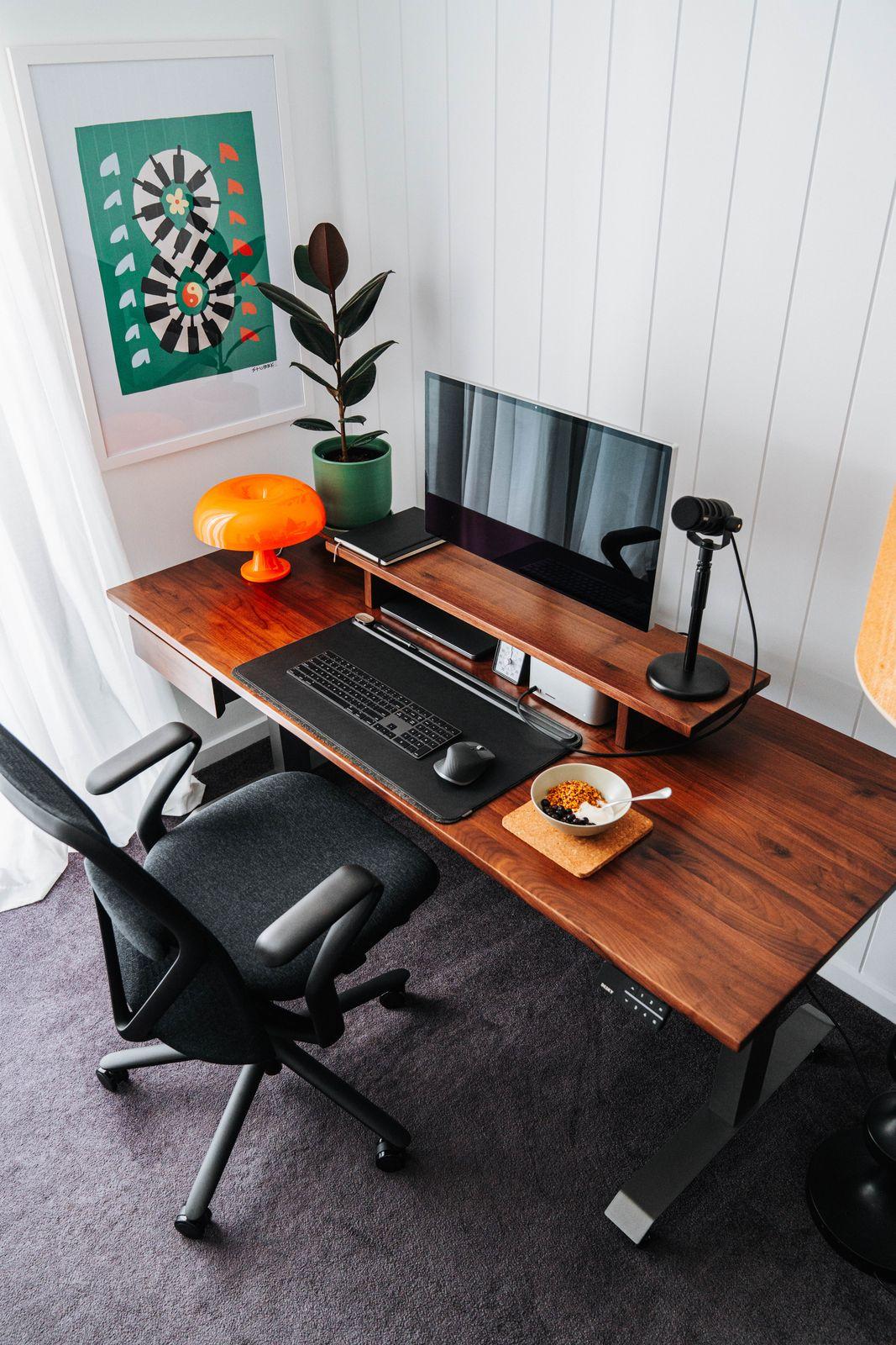 a desk with a computer and a chair