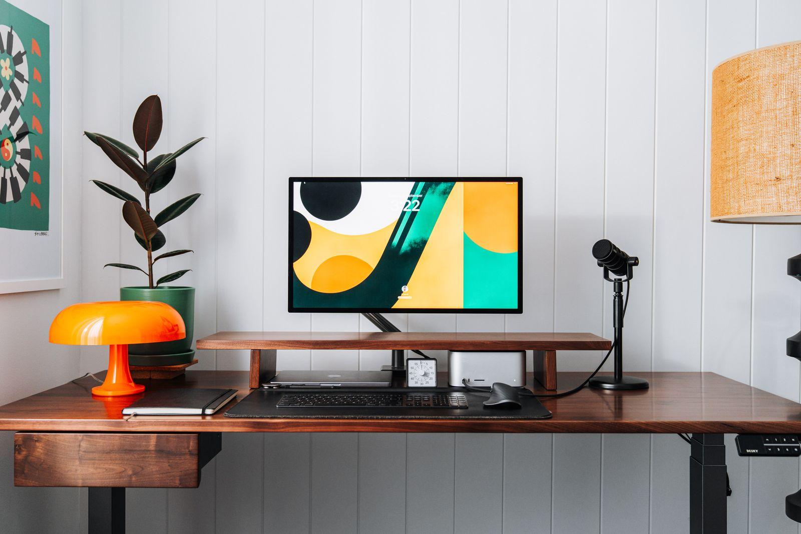 a computer monitor sitting on top of a wooden desk