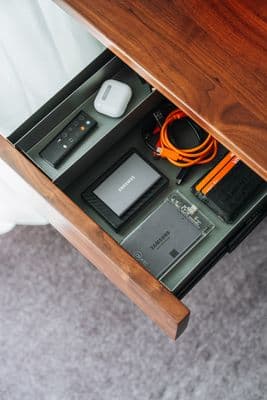 a drawer that has a bunch of electronics inside of it