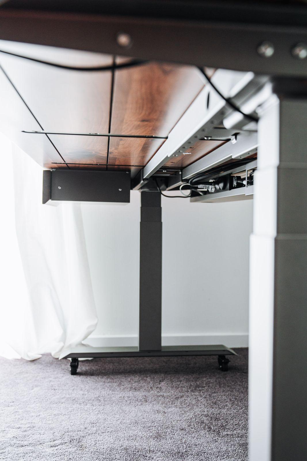 a computer desk with a laptop on top of it