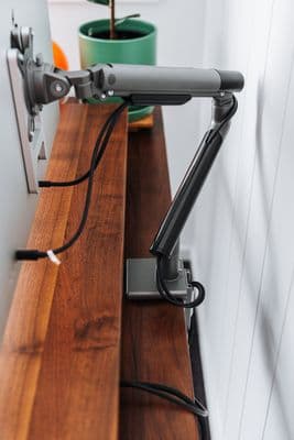 a desk with a laptop and a lamp on top of it