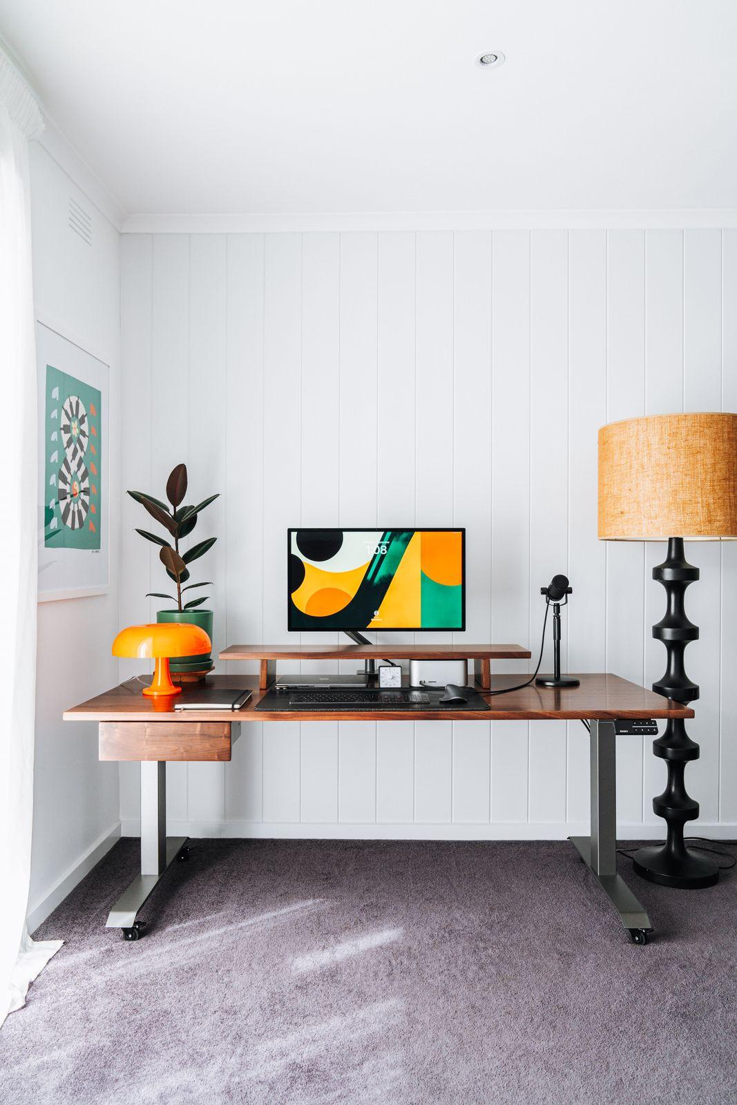 a desk with a computer on top of it