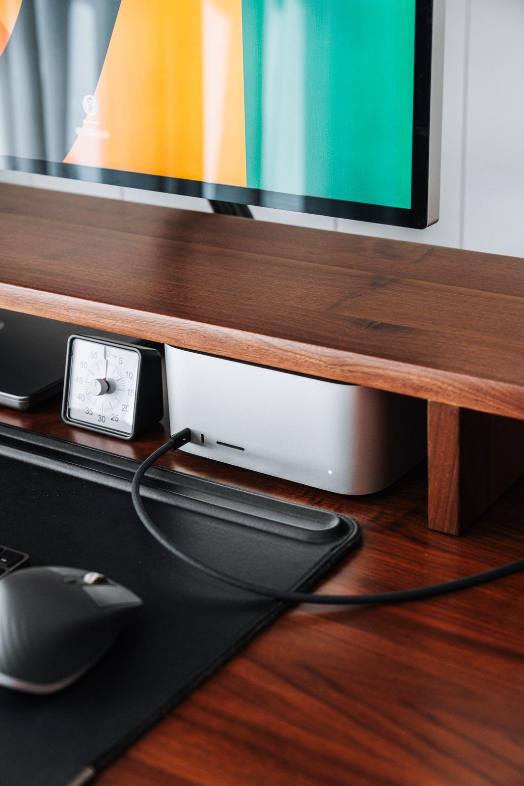 a computer monitor sitting on top of a wooden desk