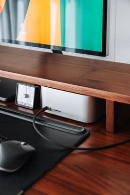 a computer monitor sitting on top of a wooden desk