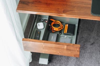 a drawer with a cord and a charger in it