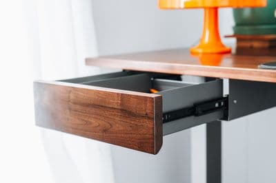 a wooden desk with a drawer underneath it