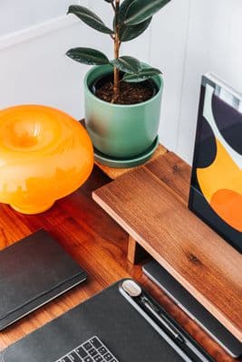 a laptop computer sitting on top of a wooden desk