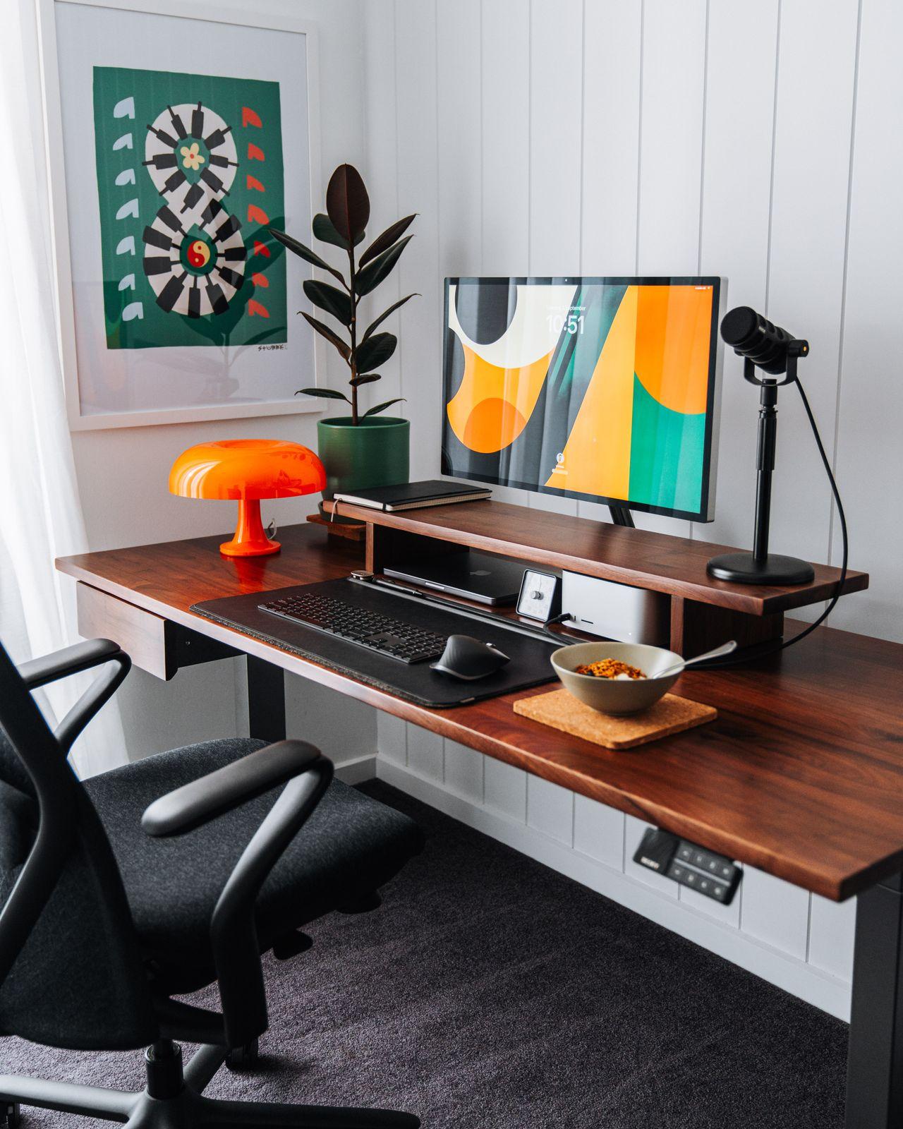 a desk with a computer and a chair