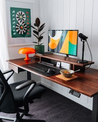 a desk with a computer and a chair