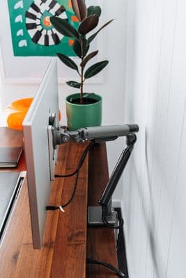 a computer monitor sitting on top of a wooden desk