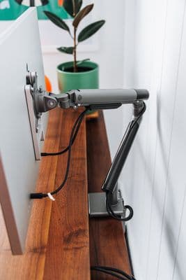 a computer monitor sitting on top of a wooden desk