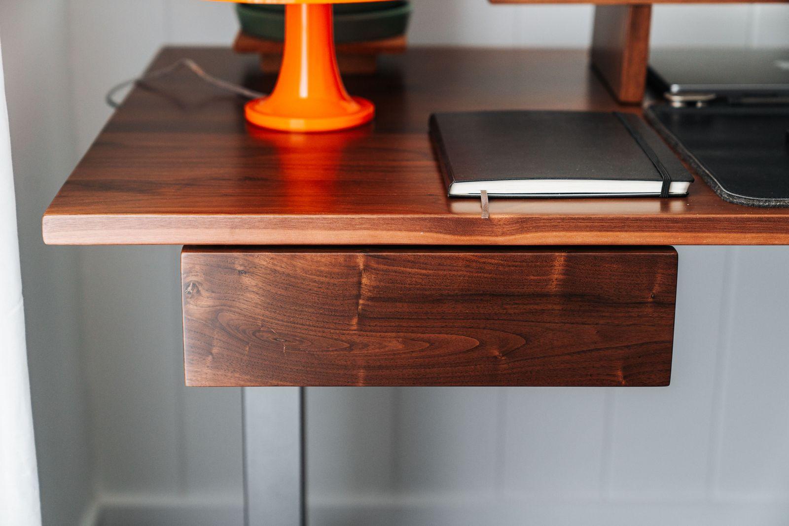 a desk with a laptop and a phone on it