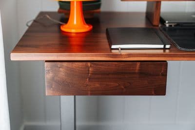 a desk with a laptop and a phone on it