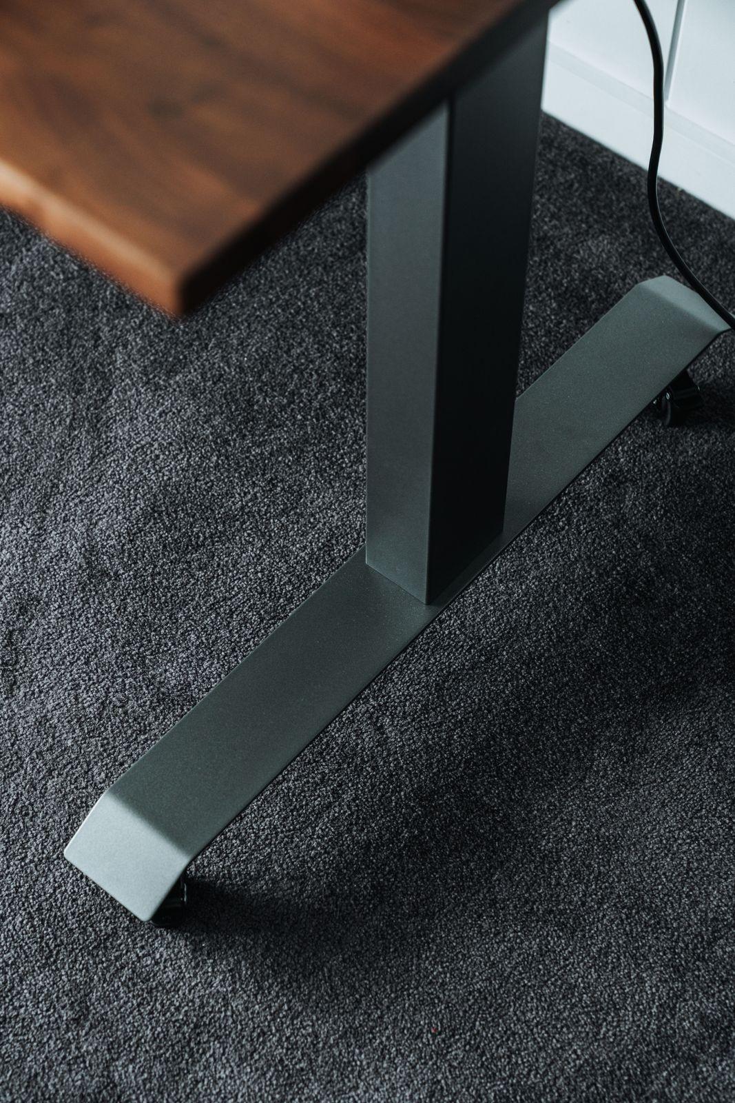 a wooden table sitting on top of a carpeted floor
