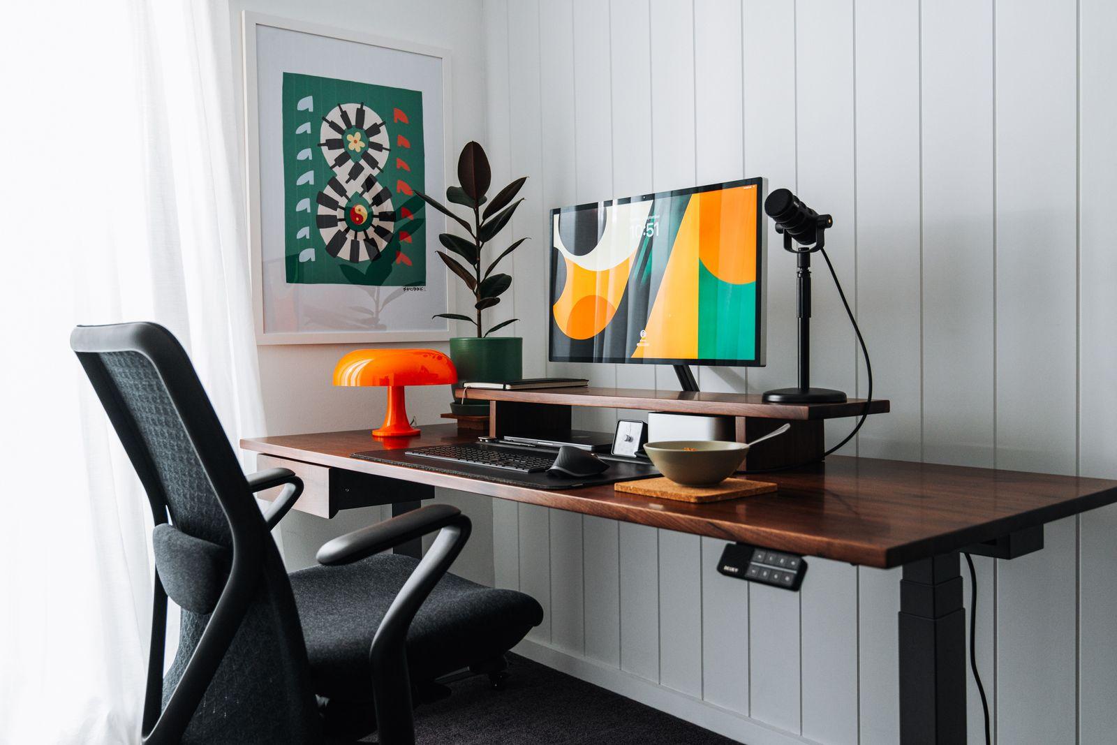 a desk with a computer and a chair