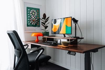 a desk with a computer and a chair