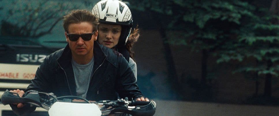 a man riding a motorcycle next to a woman