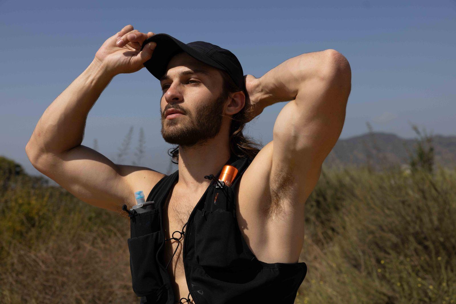 a man in a black shirt and a black hat