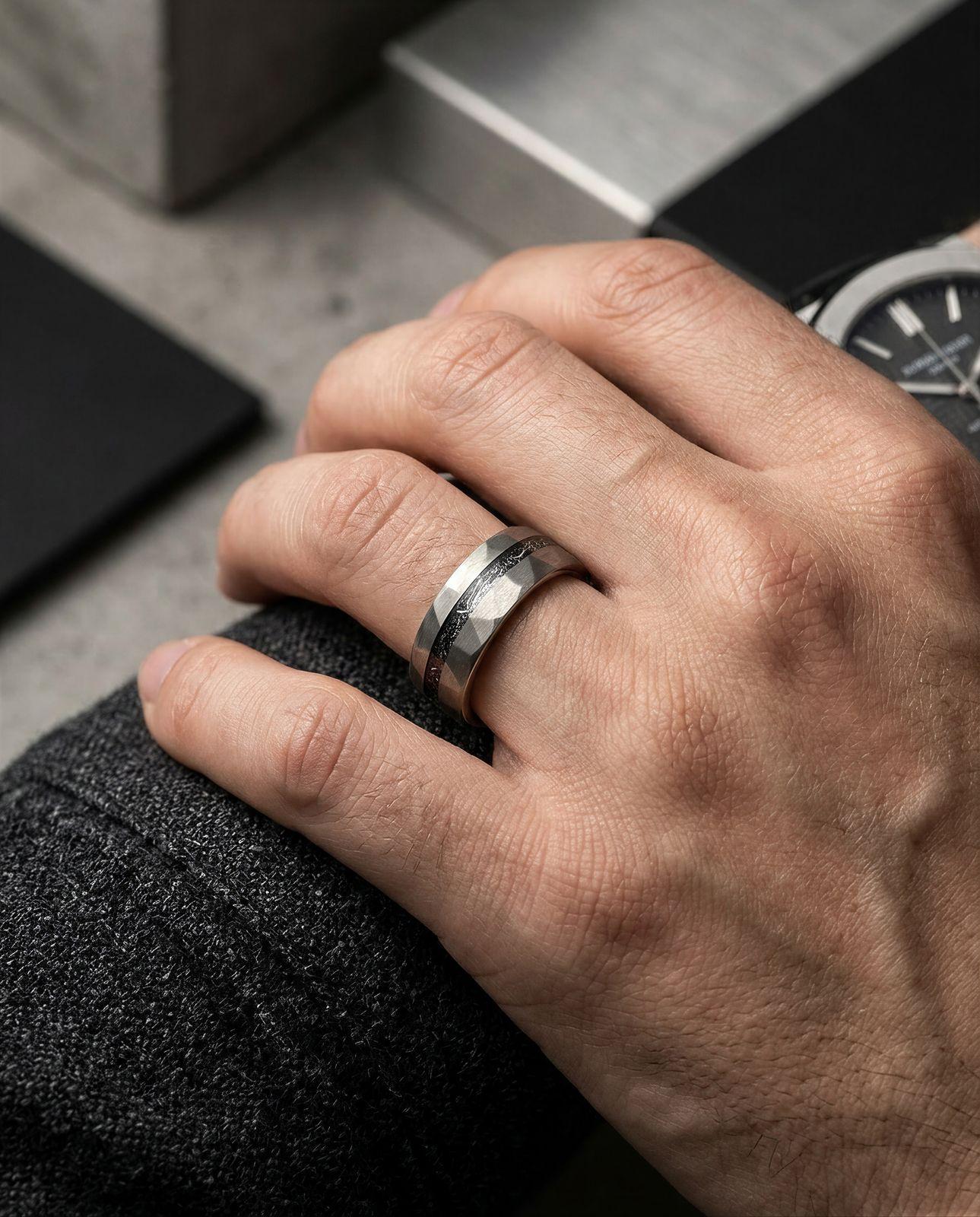 a man wearing a wedding band and a watch