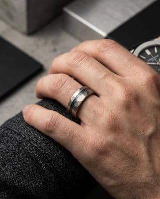 a man wearing a wedding band and a watch
