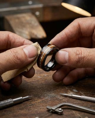 a man is working on a ring in his workshop