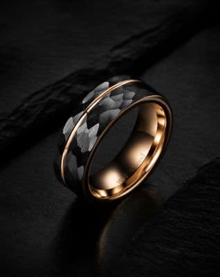 a black and gold ring with a flower pattern