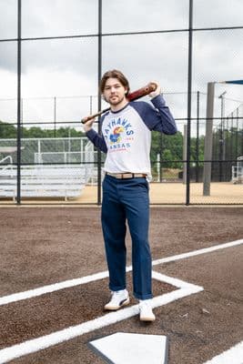 a man holding a baseball bat on a baseball field