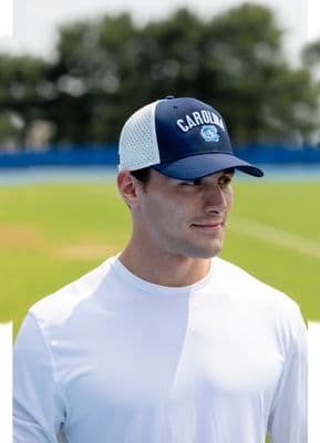 a man in a cap is standing on a baseball field