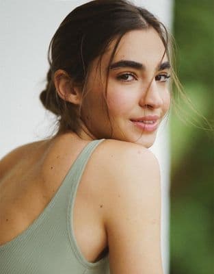 a close up of a person wearing a tank top