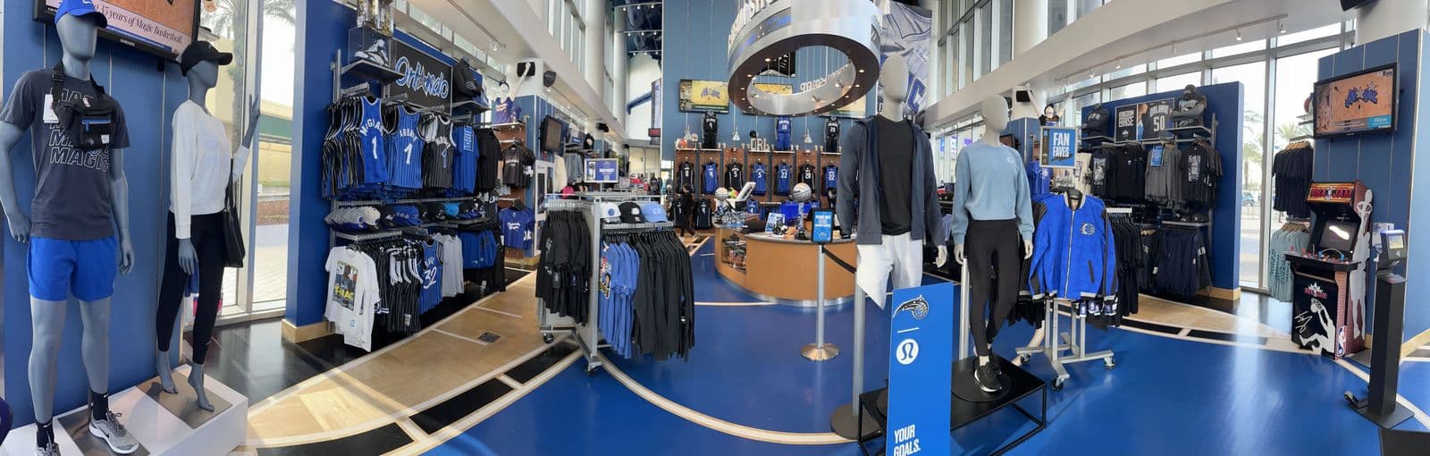 a store with a blue floor and a large mirror