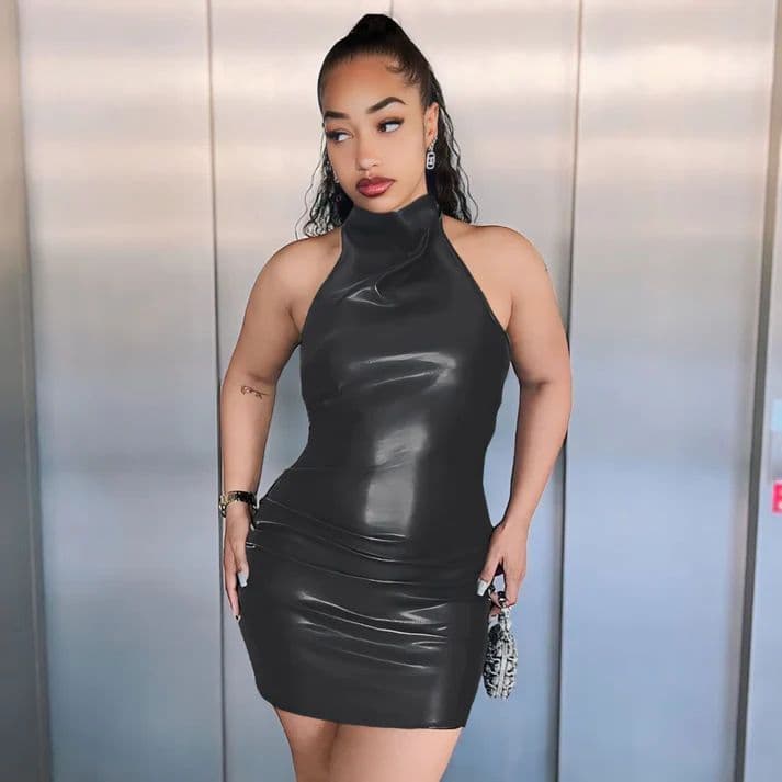 a woman in a black dress posing for a picture