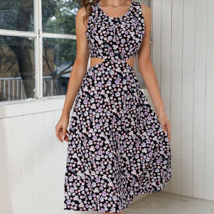 a woman wearing a black and white floral dress