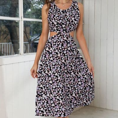 a woman wearing a black and white floral dress