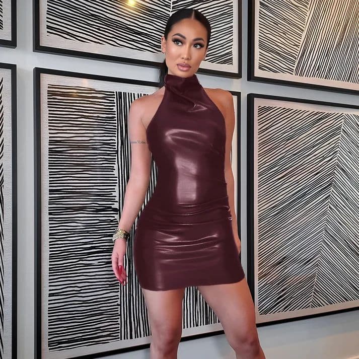 a woman in a leather dress posing for a picture
