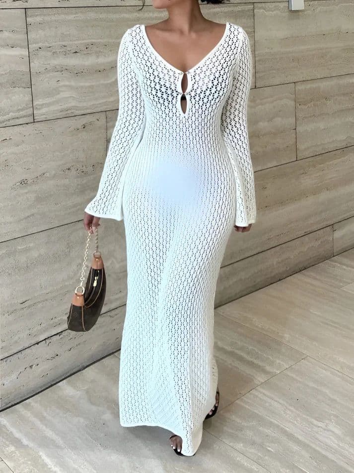 a woman wearing a white knitted dress