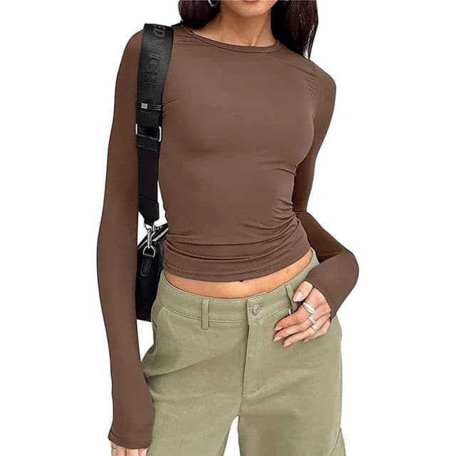 a woman wearing a brown shirt and green pants