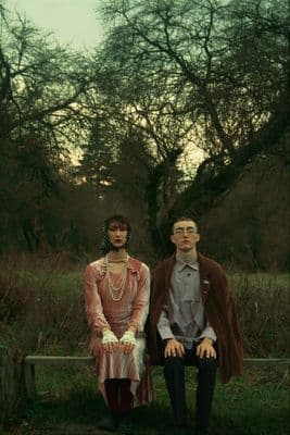 a man and a woman sitting on a bench