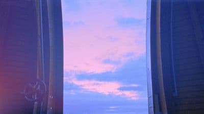 a view of the sky through two windows