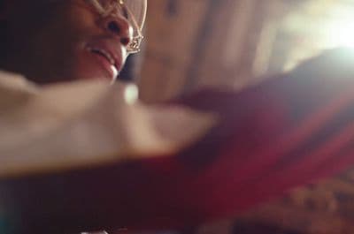 a close up of a person wearing glasses