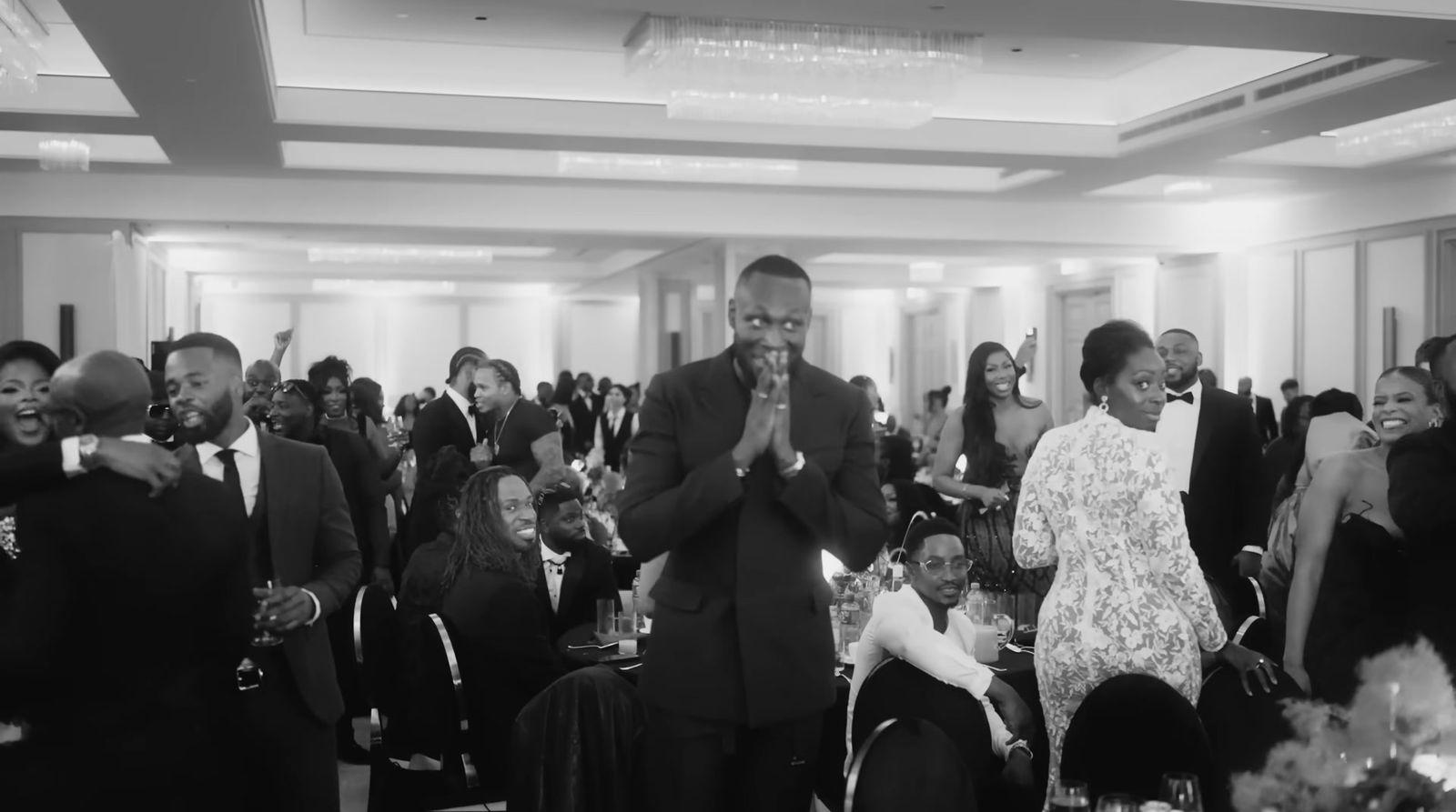 a group of people standing around each other in a room