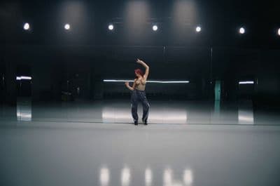 a man is dancing in a dark room