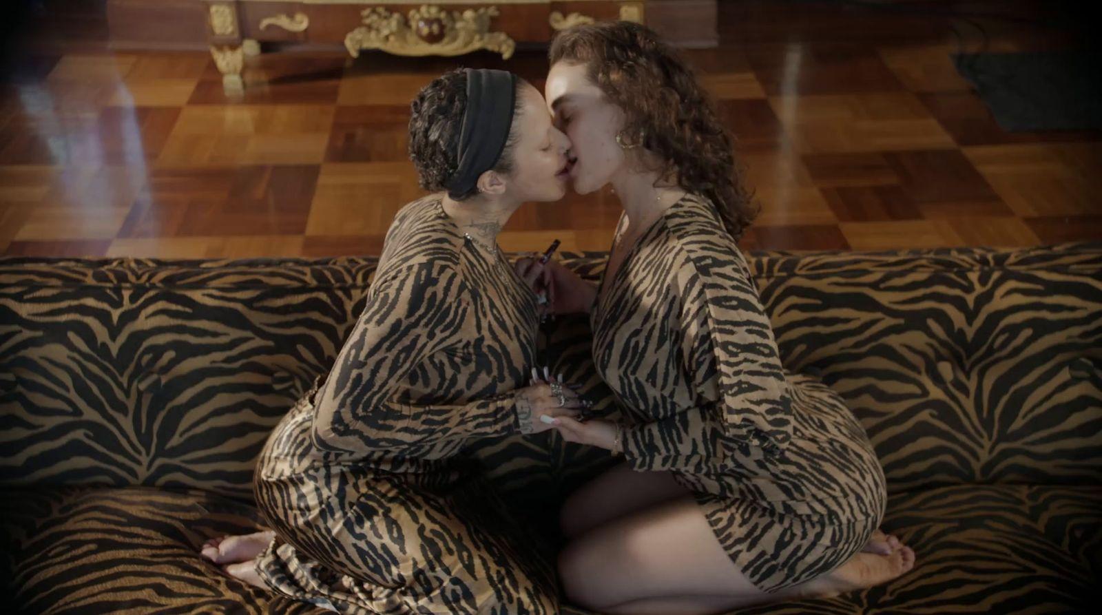 a couple of women sitting on top of a couch