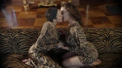a couple of women sitting on top of a couch