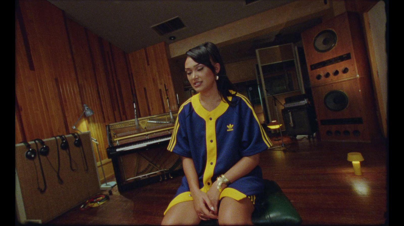 a woman sitting on a stool in a room