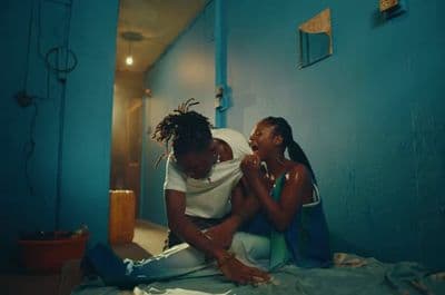 a couple of women sitting on top of a bed