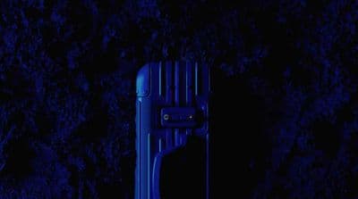 a blue piece of luggage sitting in the dark