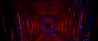 a long hallway with red and blue lights